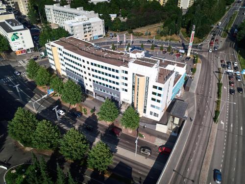an aerial view of a white building on a city street at GreenStar Hotel Lahti in Lahti