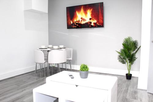 a living room with a fireplace on the wall at Reads Jacuzzi Suites & Apartments in Blackpool