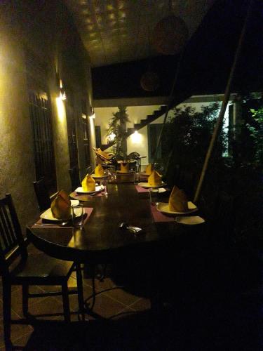 a dining room with a table with hats on it at Vimanra Udawalawa in Udawalawe