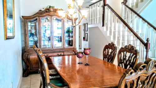 a dining room with a wooden table and chairs at Beach and Bay MediterraneanTownhouse in St. Pete Beach