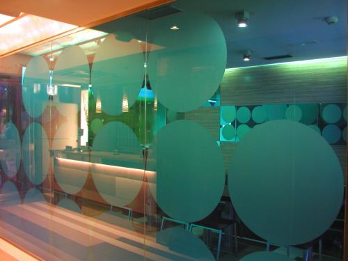 a glass window with green circles on it at Hotel Moon in A Coruña