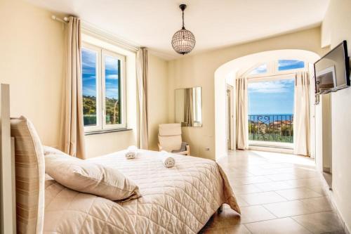 a bedroom with a bed with a view of the ocean at Casa Rosada in Massa Lubrense