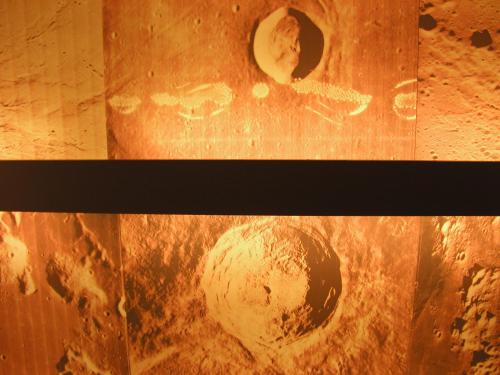 two pictures of the earth on a wooden wall at Hotel Moon in A Coruña
