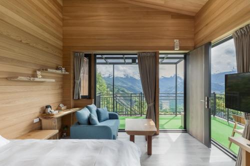 a bedroom with a bed and a large window at Chingjing Abin Minshuku in Renai