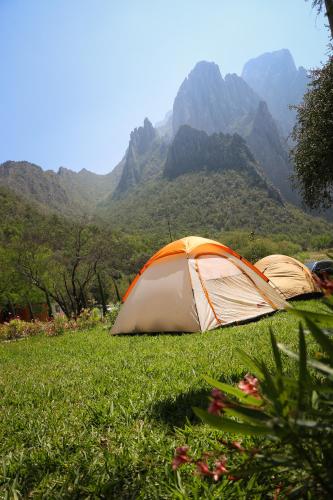two tents in a field with mountains in the background at Vista Potrero - Hotel, Camping & Events in Hidalgo