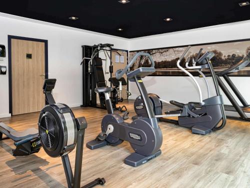 a gym with several exercise bikes in a room at Hotel Mercure Blois Centre in Blois