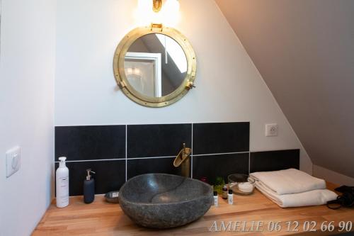 a bathroom with a large tub and a mirror at Le lit de la Saâne in Auzouville-sur-Saâne