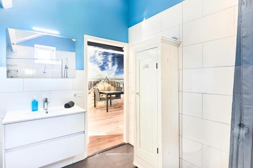 a white bathroom with a sink and a table at RIANT APPARTEMENT CENTRUM MIDDELBURG in Middelburg