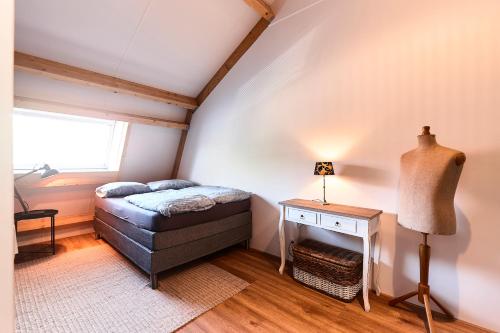 a small bedroom with a bed in a attic at RIANT APPARTEMENT CENTRUM MIDDELBURG in Middelburg