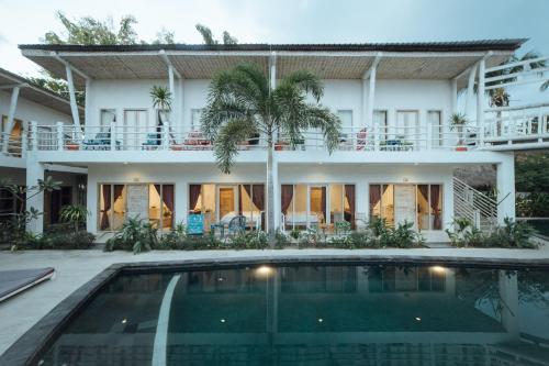 a house with a swimming pool in front of it at Gili Amor Boutique Resort in Gili Trawangan