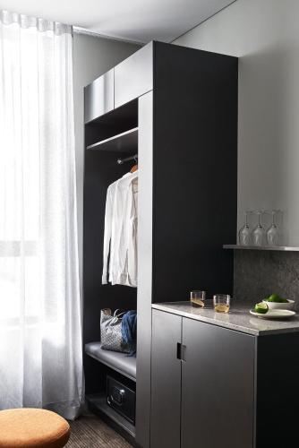 a black and white room with a closet at Veriu Green Square in Sydney