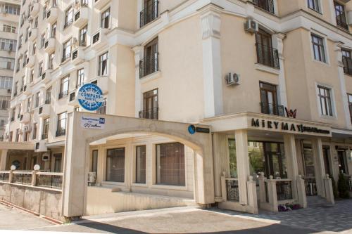 a large building with an arch in front of it at Compass Hostel in Bishkek