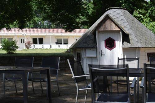 a table and chairs in front of a house at Ferienpark-Canow in Canow