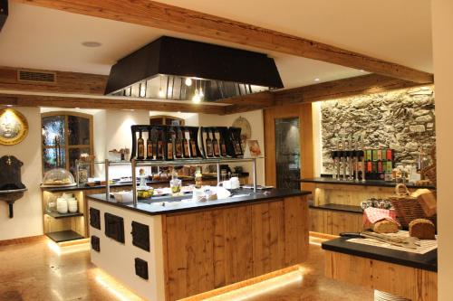 a kitchen with an island in the middle of a room at Romantikhotel Zell am See in Zell am See