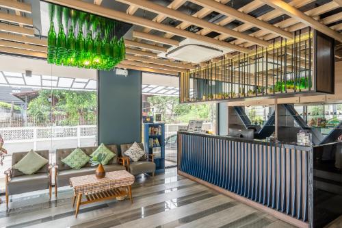 a lobby of a restaurant with a bar with green glasses at W Station in Bangkok