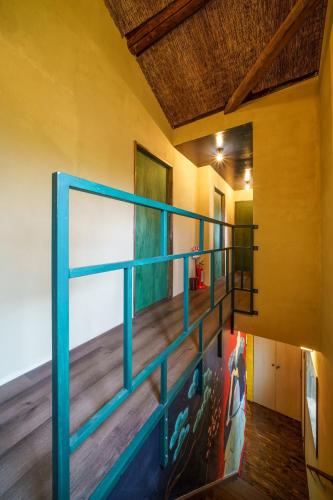 a staircase in a house with a blue railing at Mad Cat Hostel Osaka & Bar in Osaka