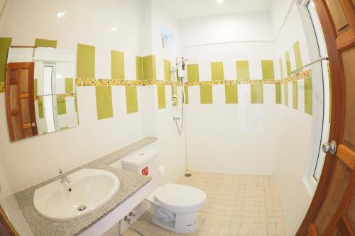 a bathroom with a sink and a toilet at Wandee Bed & Breakfast in Khao Lak