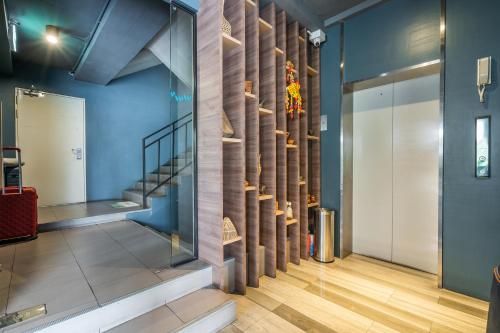 a staircase in a room with a wall of wood at W Station in Bangkok