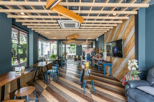 a restaurant with wooden ceilings and tables and chairs at W Station in Bangkok