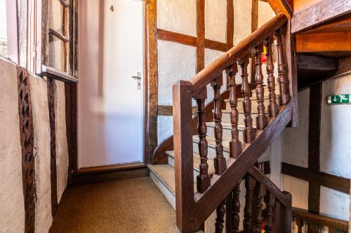 a stairway with a wooden stair case in a house at Hotel Le Port Neuf in Bayonne