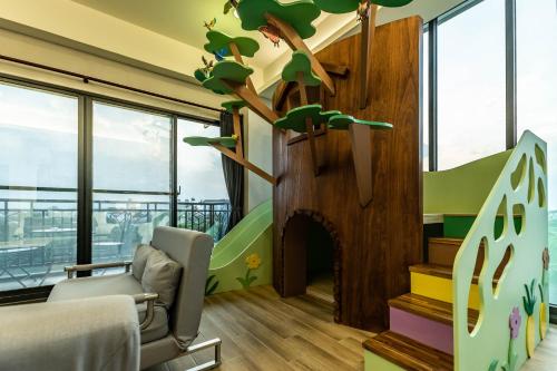 a childrens room with a tree on the wall at 123 Hall in Wujie