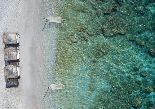 an aerial view of a beach and the ocean at Proteas Blu Resort in Pythagoreio