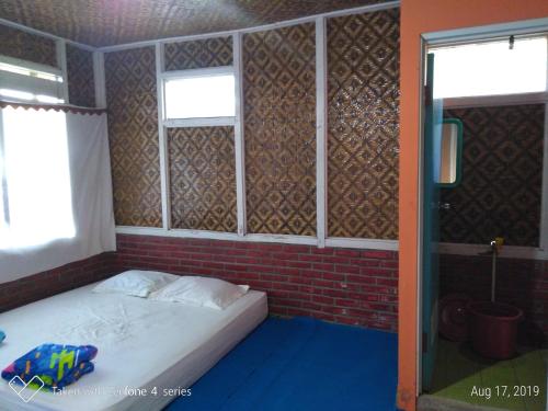 
A bed or beds in a room at Rumah Sakinah
