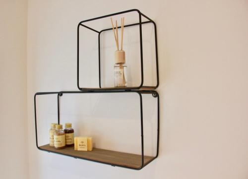 a shelf with two glass shelves on a wall at Bennestay in Ghent