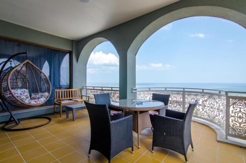 a balcony with chairs and a table and a swing at Phoenicia Boutique Hotel - Adults Only in Mamaia Sat/Năvodari