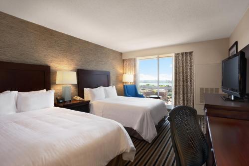a hotel room with two beds and a flat screen tv at Wyndham Boston Beacon Hill in Boston