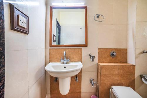 a bathroom with a sink and a mirror at FabHotel Santoor Geeta Bhawan Square in Indore