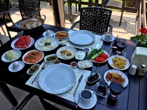 a table with plates of food on top of it at Alya Hotel Göcek in Göcek
