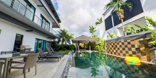 an image of a swimming pool at a hotel at Eden Villa Phuket in Bang Tao Beach