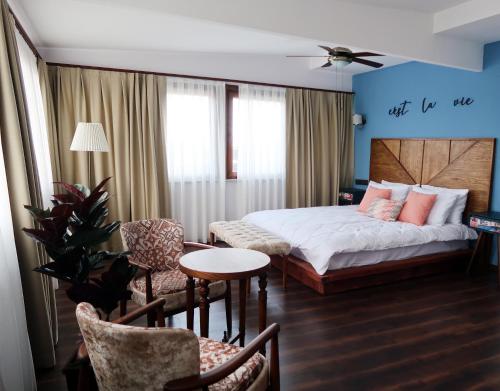a bedroom with a bed and a table and chairs at Fuego Design Suites in Istanbul
