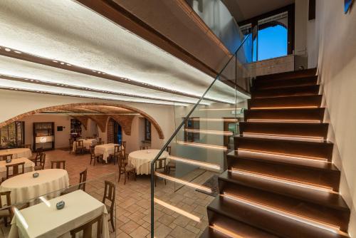 a staircase leading to a dining room with tables at Il Vigneto in Roddi