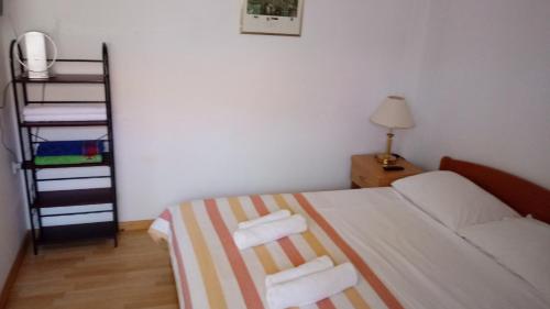 a small bedroom with a bed with towels on it at HappY ApartmenT Dubrovnik centre-free parking in Dubrovnik