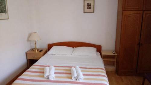a bedroom with a bed with two towels on it at HappY ApartmenT Dubrovnik centre-free parking in Dubrovnik