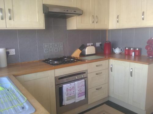 a kitchen with white cabinets and a stove top oven at sunrise view in Trimingham