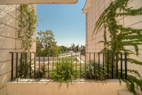 a balcony with plants on the side of a building at Hotel Admiral in Budva