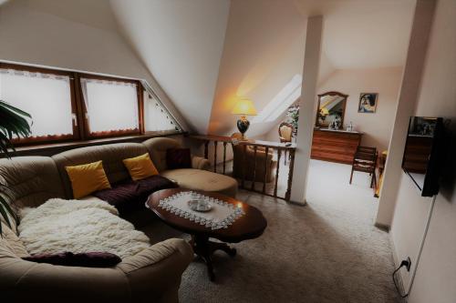 a living room with a couch and a table at Penzion Panda in Turčianske Teplice