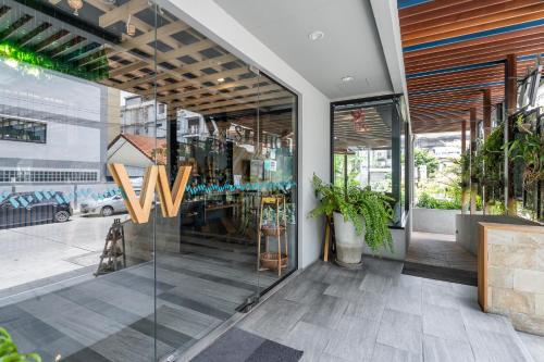 a store front with a large glass door at W Station in Bangkok