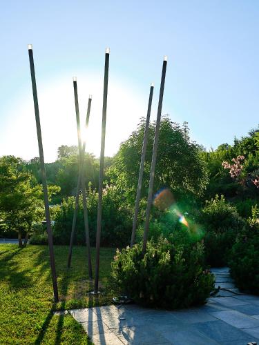 a garden with a group of poles in the grass at Relais Villa D'Amelia in Benevello