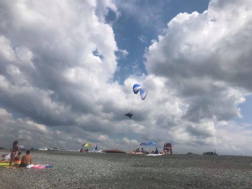 a kite flying in the sky on the beach at Dito House in K'obulet'i