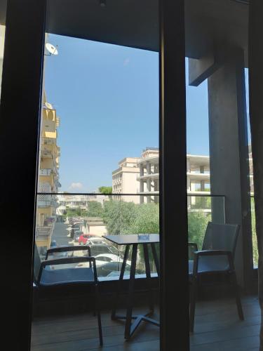 a balcony with a table and chairs and a view of a street at Supreme Hotel in Golem
