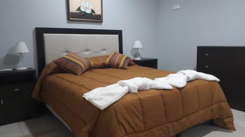 a bedroom with a bed with towels on it at Departamnto San Nicolas De Los Arroyos in San Nicolás de los Arroyos