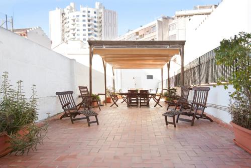 a patio with chairs and a table on a building at Rent Top Apartments near Plaza de Catalunya in Barcelona