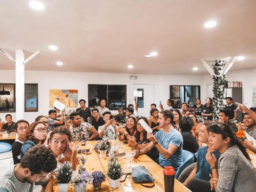 a group of people sitting around a table at Murals Hostel and Cafe in Cebu City