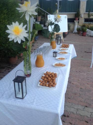 a white table with plates of food on it at "Frogs House" Hotel & Restorant Slow Food in Lushnjë