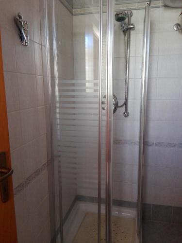 a shower with a glass door in a bathroom at Casa della camperia in Favignana