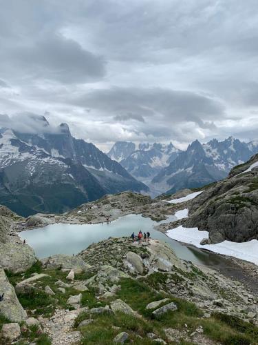 a group of people standing on a mountain near a lake at Eden Hotel, Apartments and Chalet Chamonix Les Praz in Chamonix-Mont-Blanc